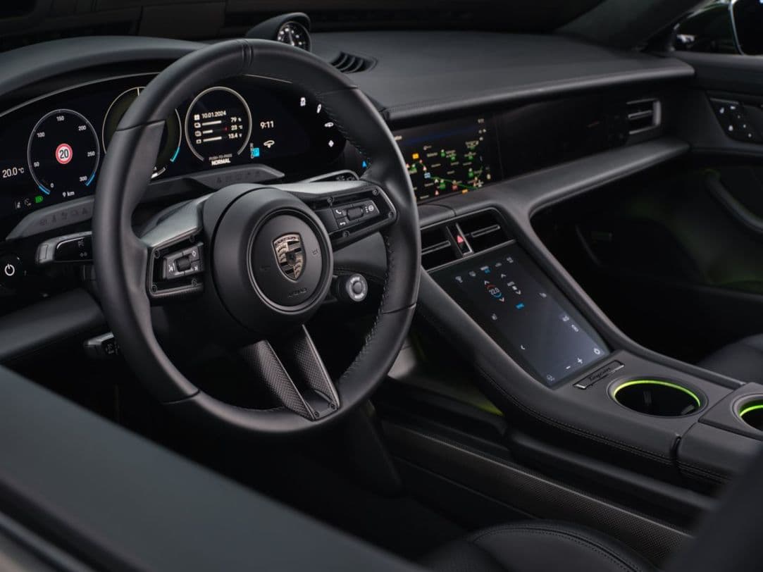 2025 Porsche Taycan with black leather interior and center console utility display.
