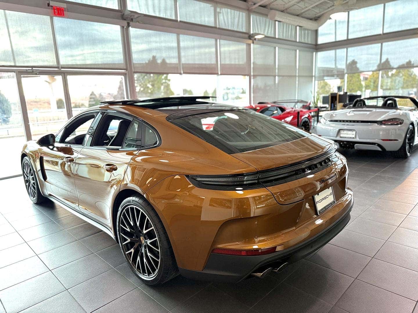 Orange Porsche Panamera on Porsche show room floor