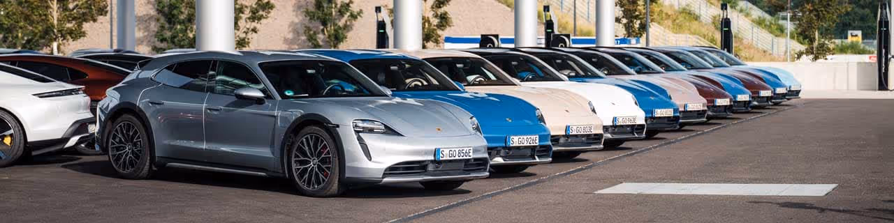A row of new Porsche Taycans parked in front of Porsche of Oklahoma city